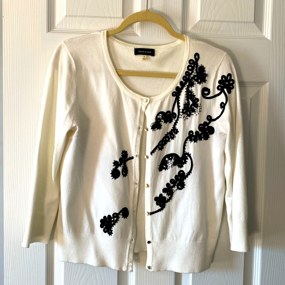 3 different white cardigan sweaters with 3/4 length sleeves.